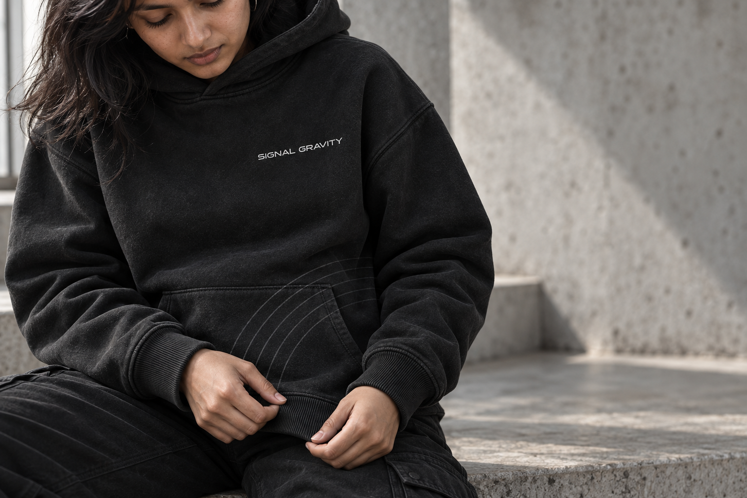 Close view of the heavyweight Signal Gravity hoodie fabric, ribbing and Field Lines stitching